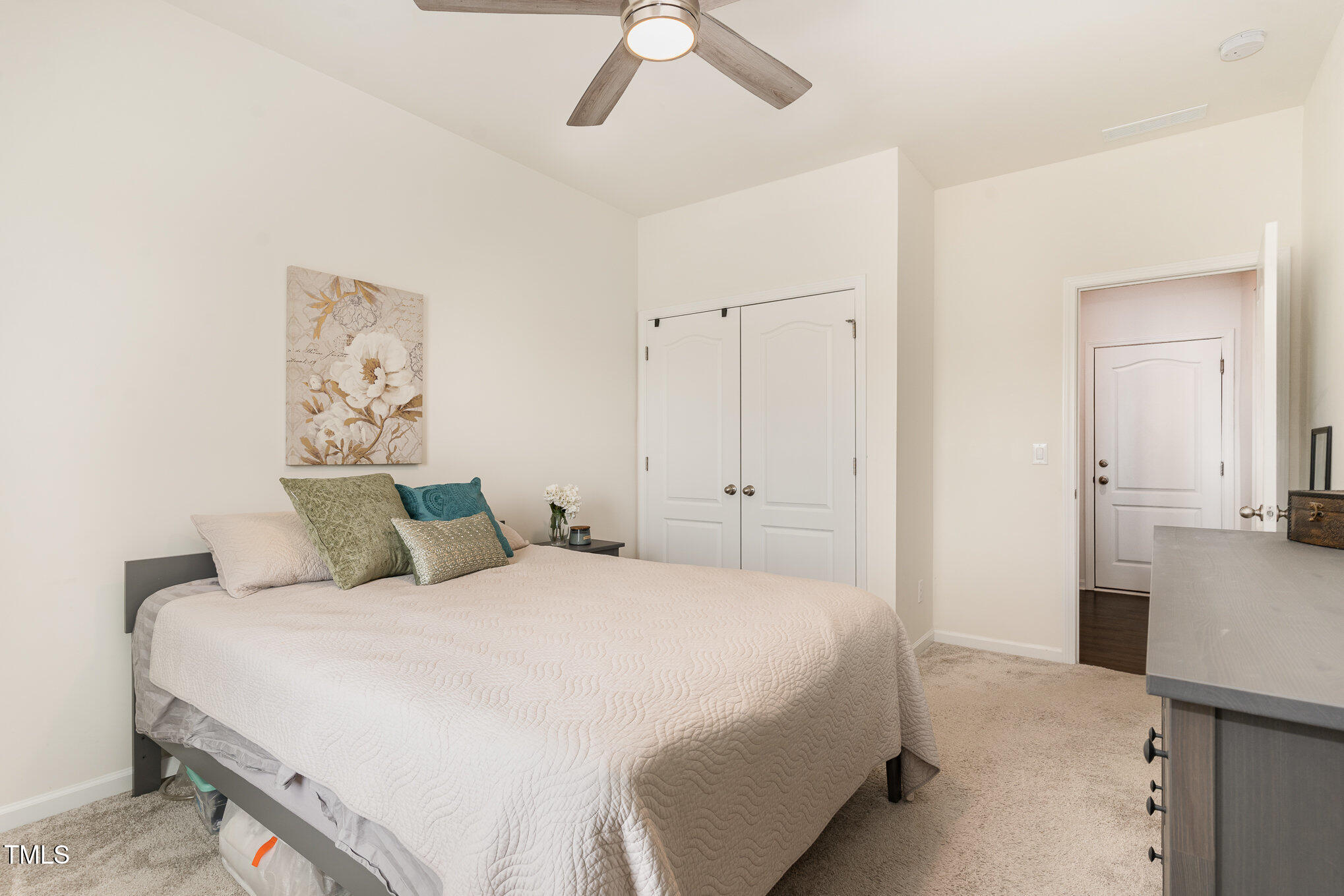 1040 Lippincott Road Durham, NC 27703 - Photo 18 of 43 a bedroom with a bed and a chandelier