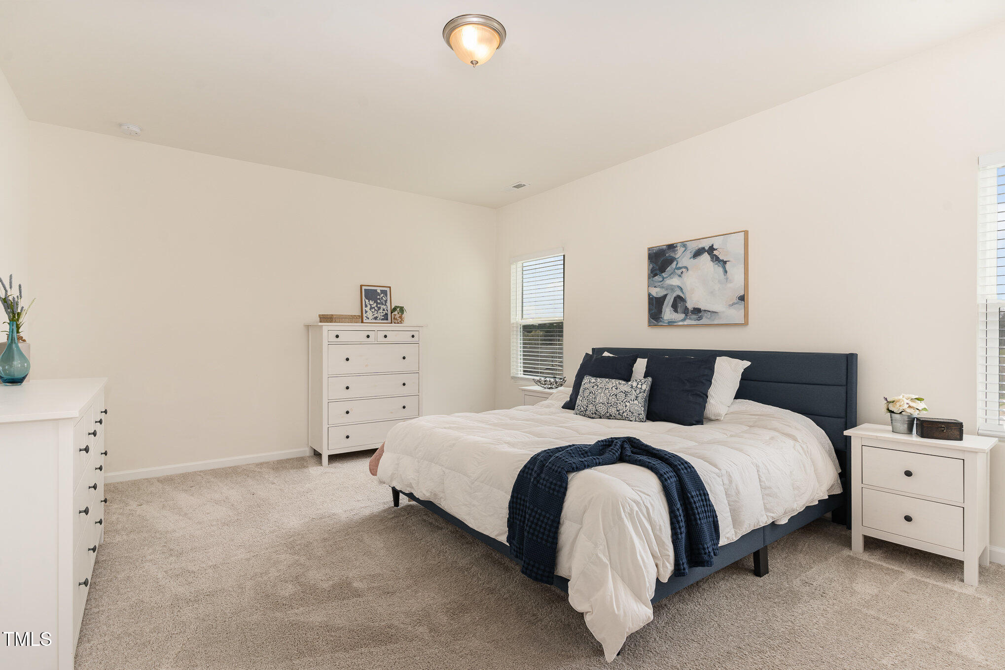 1040 Lippincott Road Durham, NC 27703 - Photo 20 of 43 a bedroom with a bed and painting on the wall