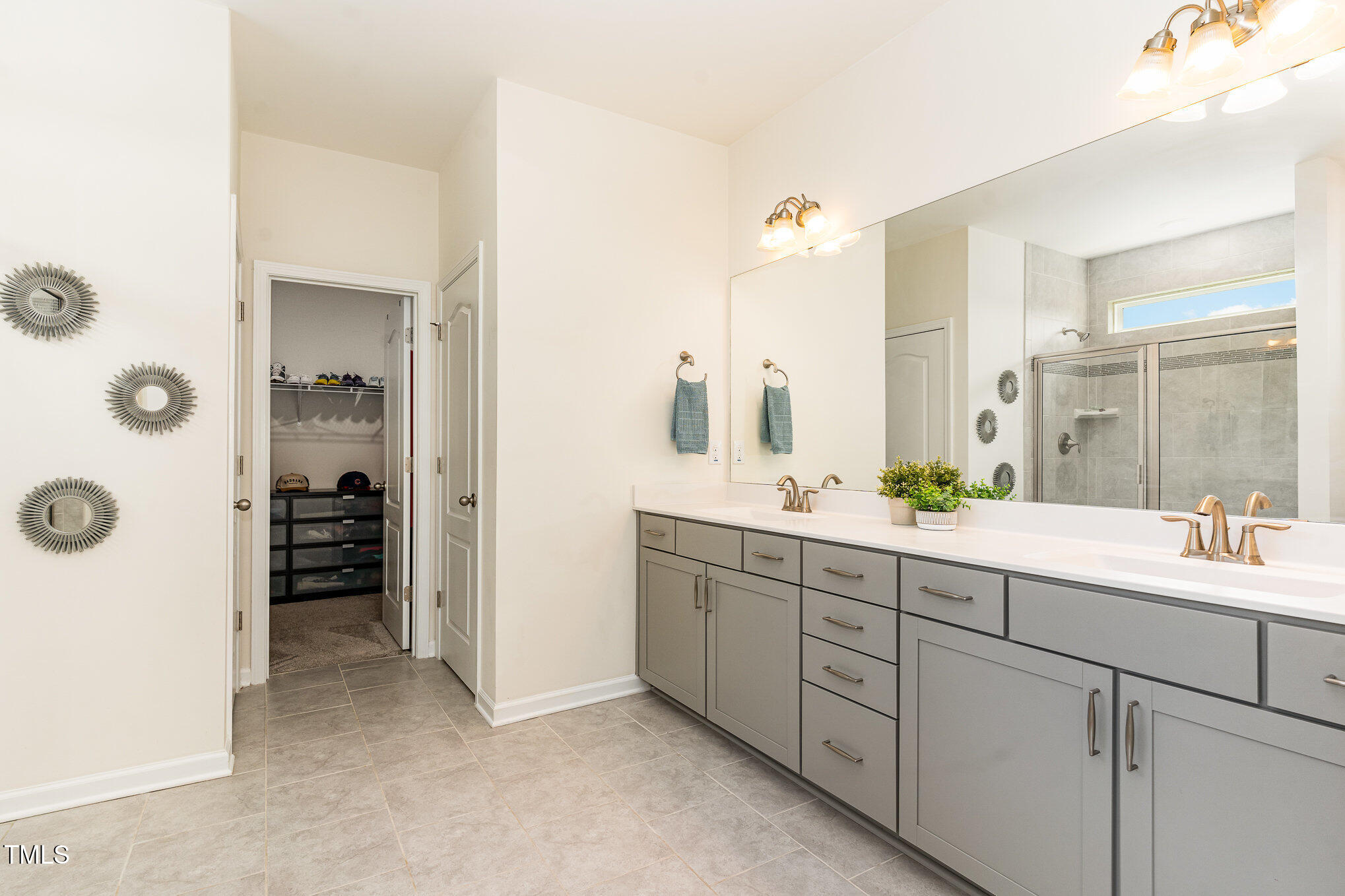 1040 Lippincott Road Durham, NC 27703 - Photo 21 of 43 a bathroom with a double vanity sink and mirror
