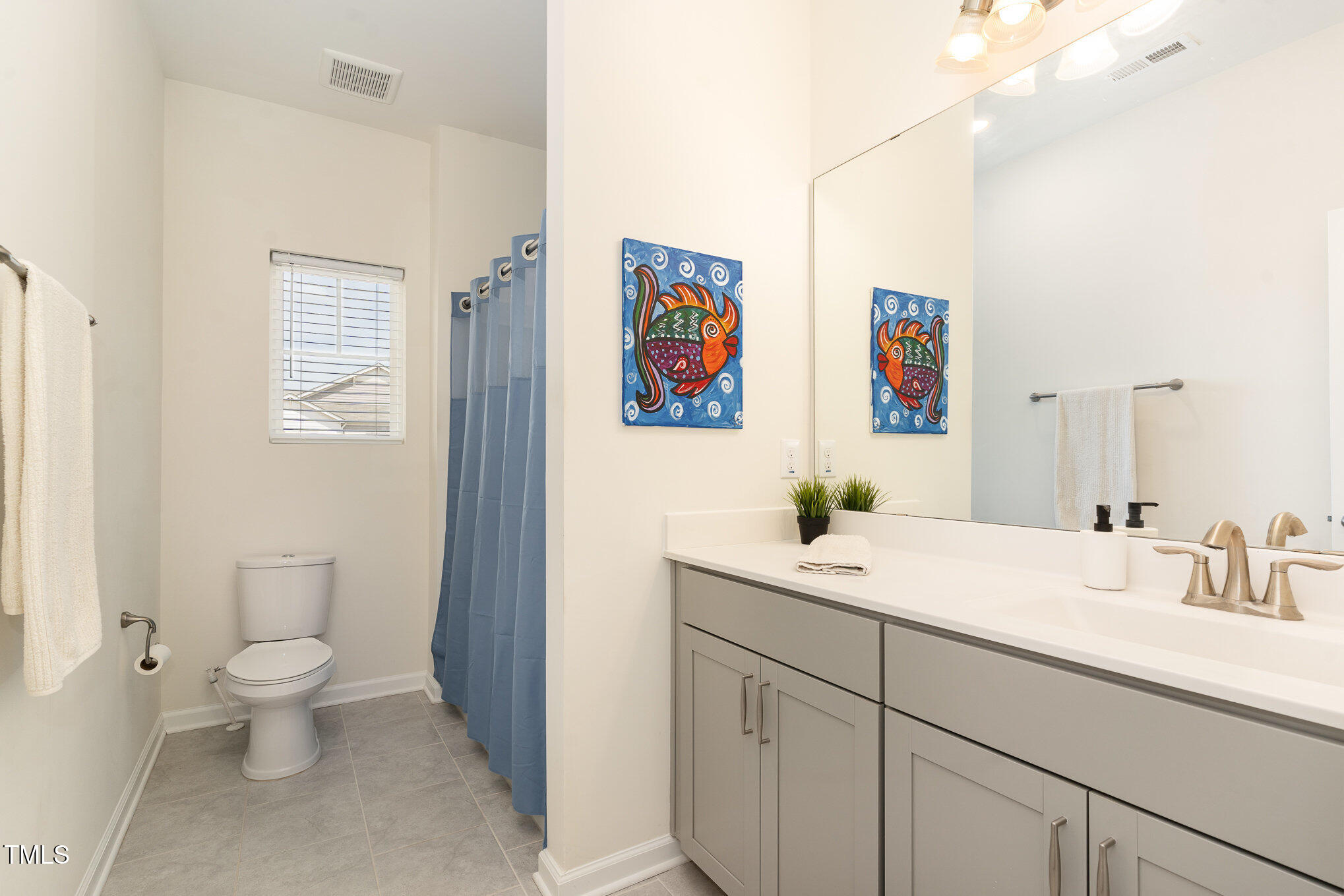 1040 Lippincott Road Durham, NC 27703 - Photo 26 of 43 a spacious bathroom with a toilet sink and mirror
