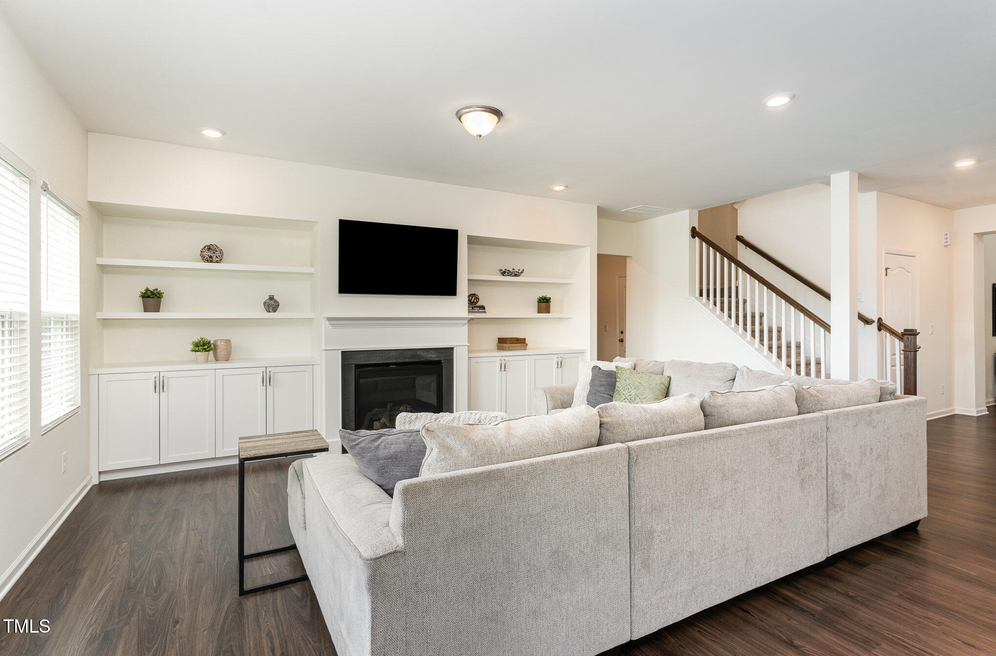 1040 Lippincott Road Durham, NC 27703 - Photo 4 of 43 a living room with furniture a flat screen tv and a fireplace