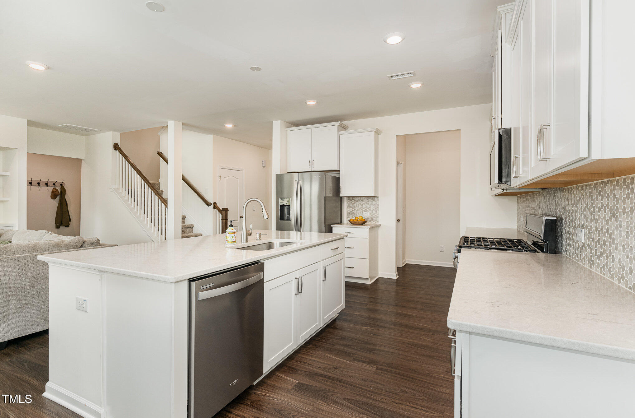 1040 Lippincott Road Durham, NC 27703 - Photo 10 of 43 a kitchen with white cabinets sink and stove