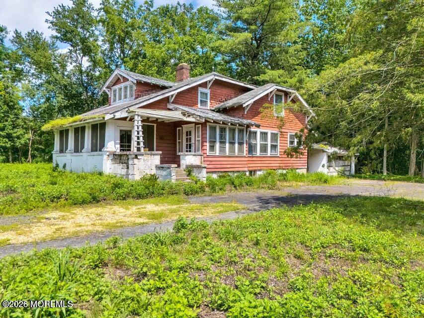 465 Lakewood Farmingdale Road Howell, NJ 07731 - Photo 7 of 19 a front view of a house with a yard