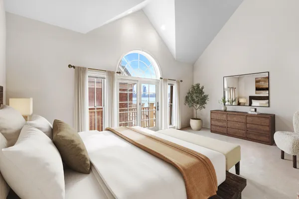 a bedroom with a large bed and a large window