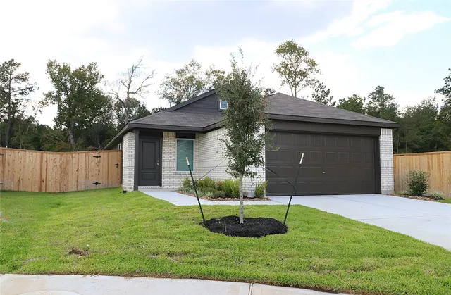 a view of a house with a yard and a garden