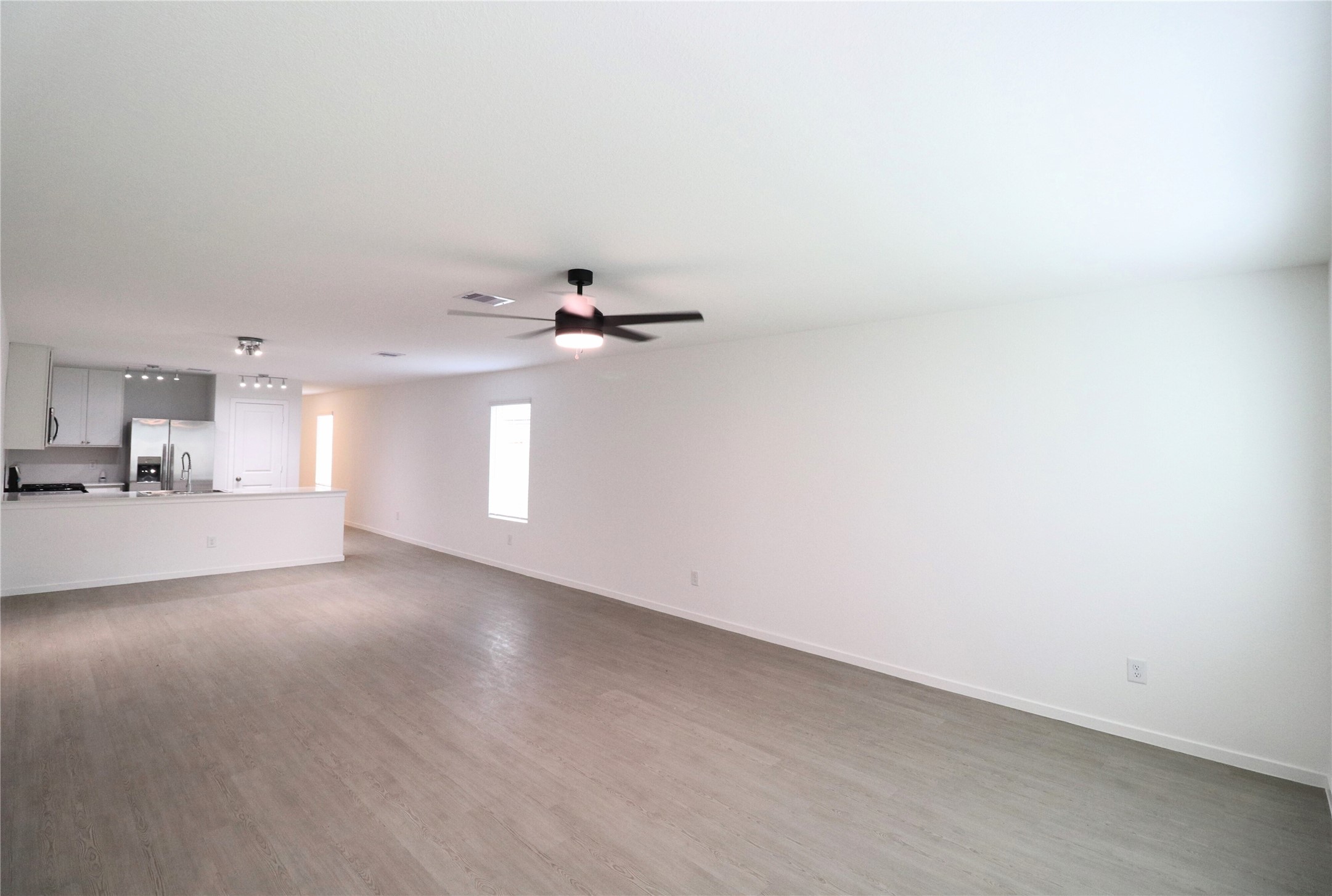 20805 Le Scifo Court New Caney, TX 77357 - Photo 14 of 20 a view of empty room with wooden floor and window
