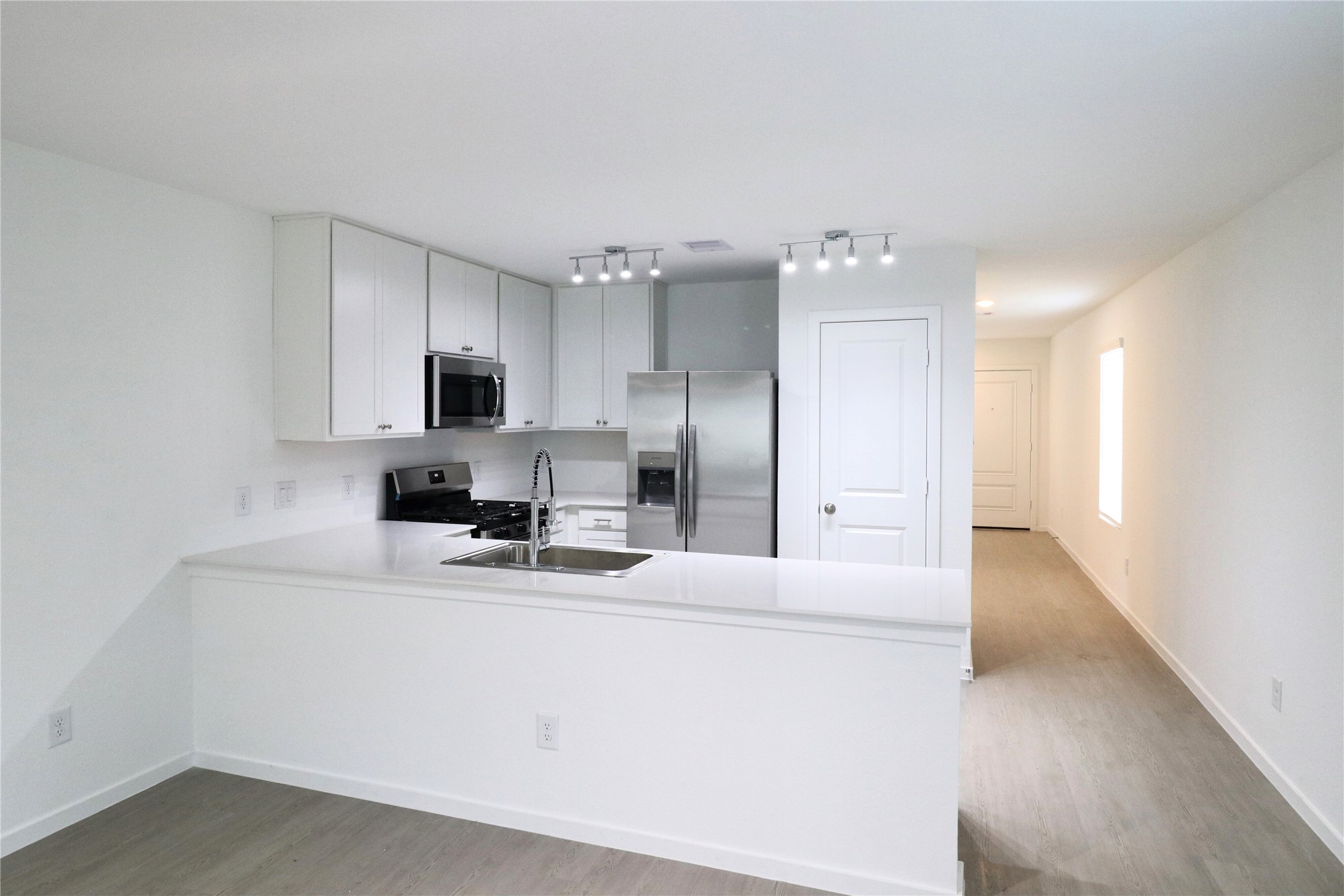 20805 Le Scifo Court New Caney, TX 77357 - Photo 15 of 20 a kitchen with cabinets and stainless steel appliances