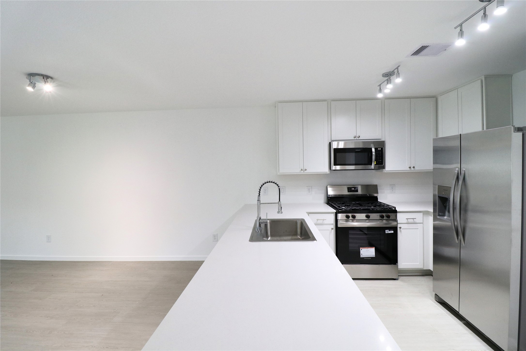 20805 Le Scifo Court New Caney, TX 77357 - Photo 17 of 20 a kitchen with granite countertop a refrigerator stove and microwave