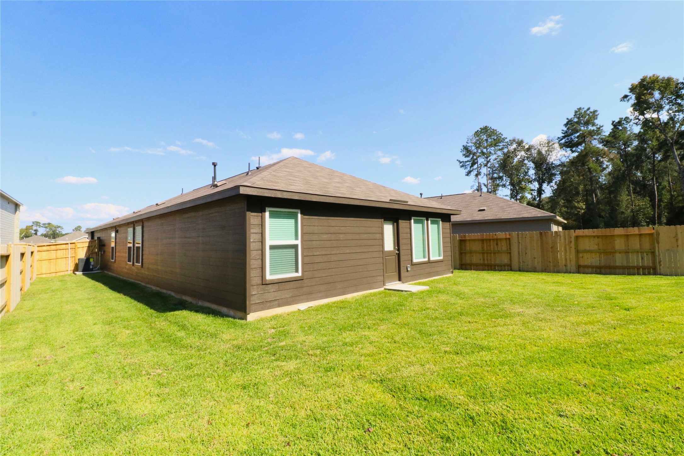 20805 Le Scifo Court New Caney, TX 77357 - Photo 19 of 20 a front view of house with yard and trees in the background