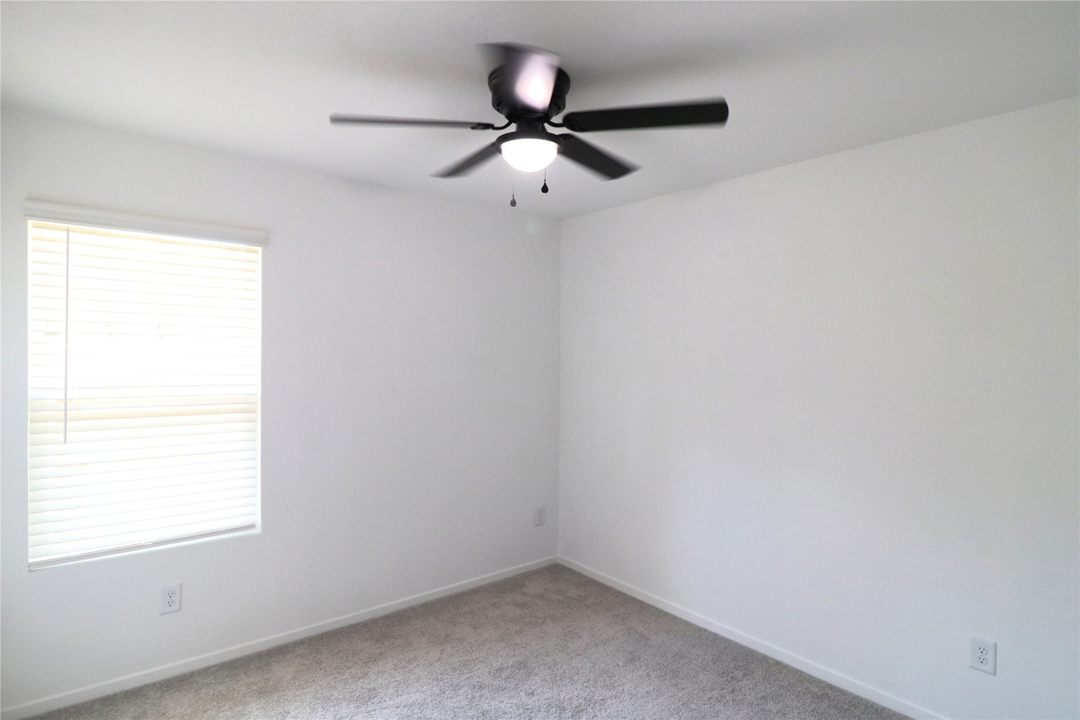 20805 Le Scifo Court New Caney, TX 77357 - Photo 6 of 20 an empty room with a window and a fan