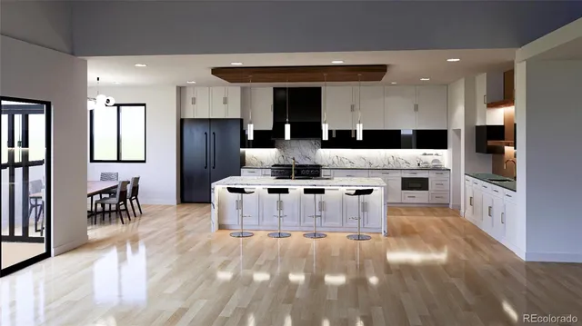 a large white kitchen with kitchen island a sink a stove a refrigerator and a dining table with wooden floor
