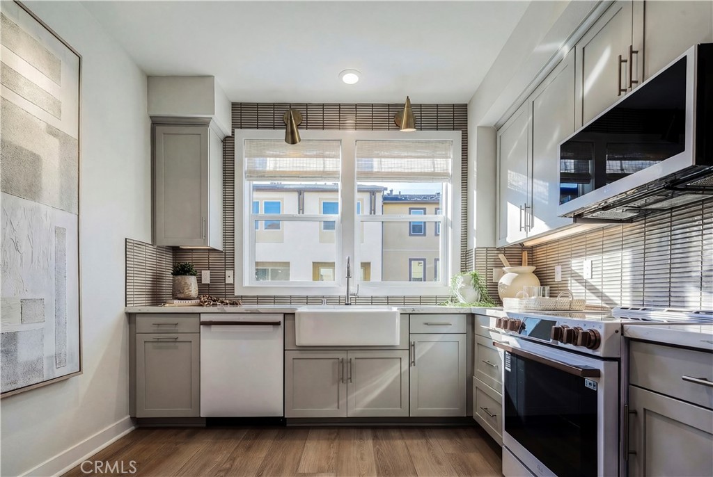12720 Azure Way, Unit 29 Hawthorne, CA 90250 - Photo 5 of 10 a kitchen with stainless steel appliances granite countertop a stove and a sink