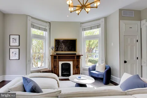 a living room with furniture a window and a fireplace