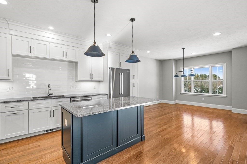 30 Cutter, Unit 30 Amesbury, MA 01913 - Photo 2 of 15 a kitchen with stainless steel appliances granite countertop wooden floors and sink