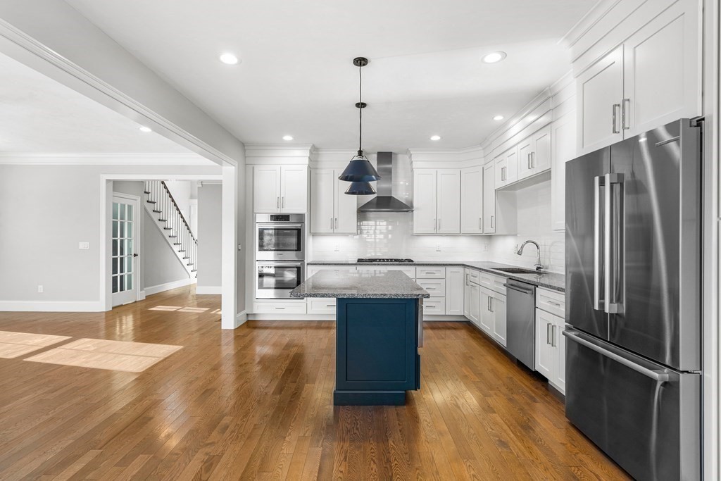 30 Cutter, Unit 30 Amesbury, MA 01913 - Photo 3 of 15 a large kitchen with stainless steel appliances granite countertop a refrigerator a sink dishwasher a stove and white countertops with wooden floor