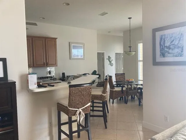 a kitchen with stainless steel appliances granite countertop a refrigerator a sink a stove and a refrigerator