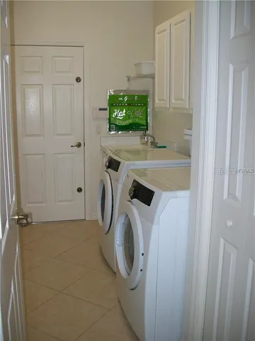 a bedroom with a bed and a dresser next to a window