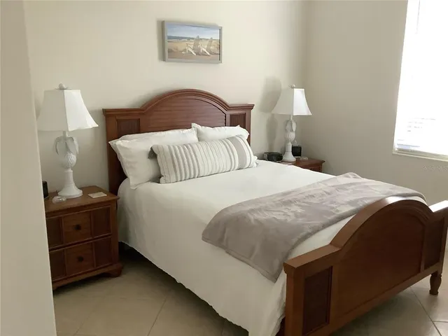 a bedroom with a bed and a lamp