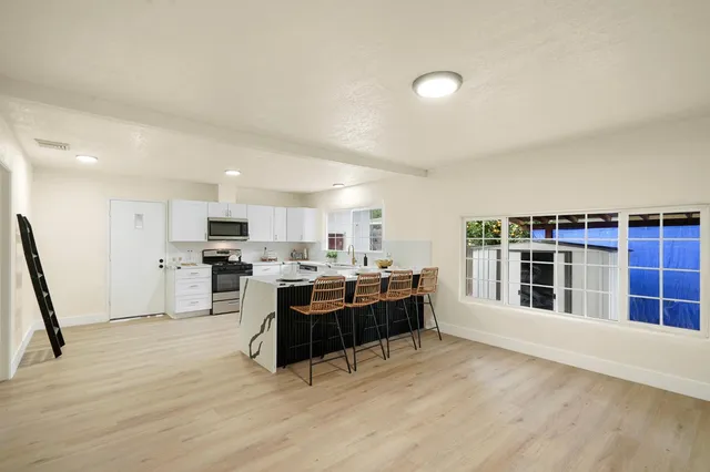 a view of kitchen and kitchen with sink