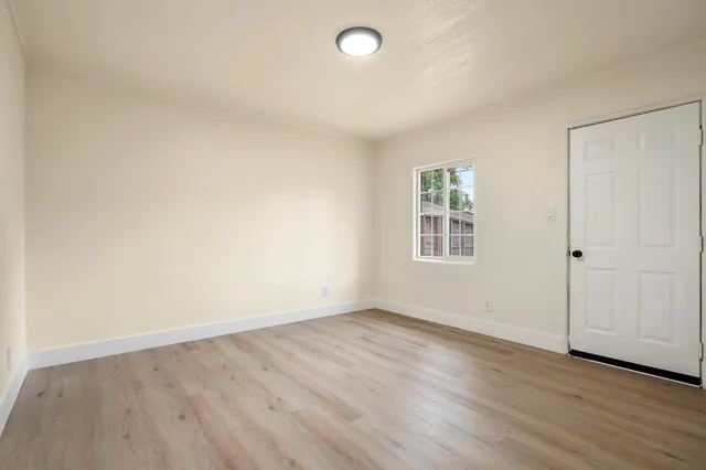 wooden floor in an empty room with a window