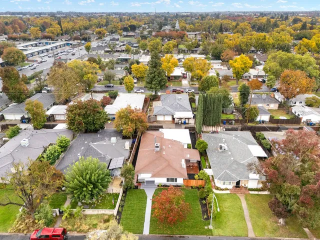 an aerial view of residential houses with outdoor space