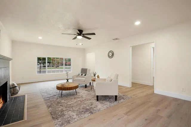 a living room with furniture a window and a fireplace