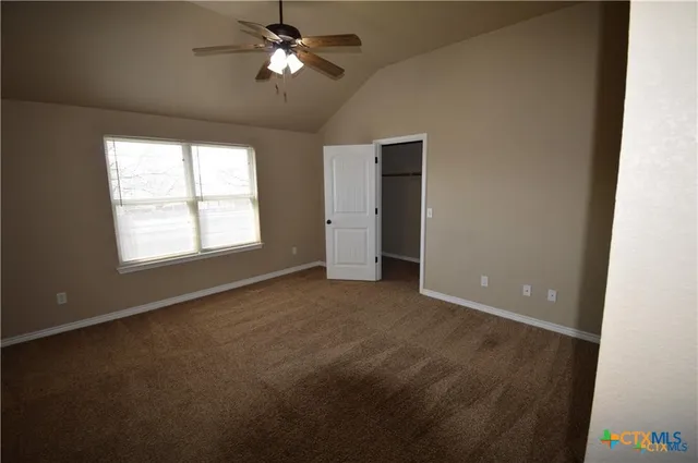 a view of a livingroom with a ceiling fan and window