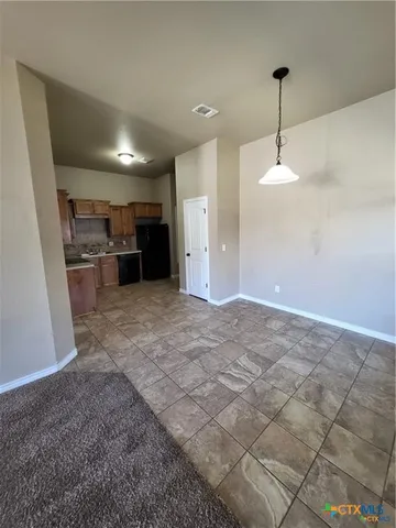 a view of a kitchen with a sink and cabinets