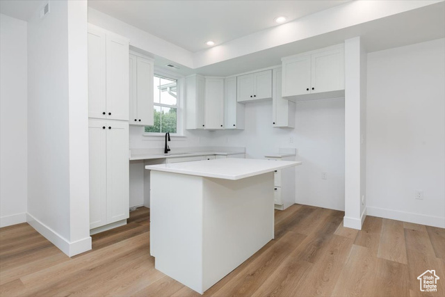 195 West 300 North Logan, UT 84321 - Photo 5 of 20 Kitchen with white cabinets, light wood finished floors, a kitchen island, and recessed lighting