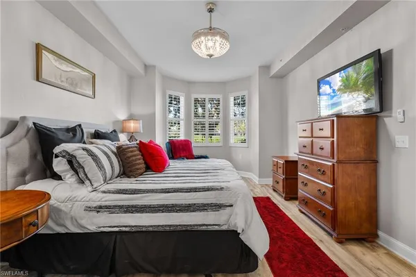 a bedroom with furniture and a flat screen tv