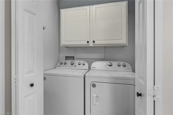 a view of storage and utility room with washer and dryer