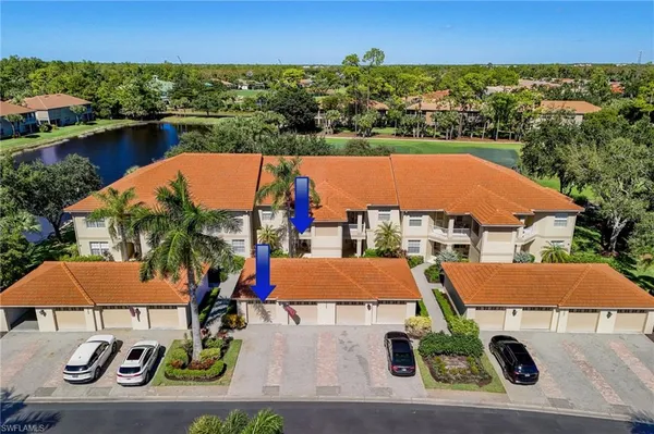 an aerial view of residential houses with outdoor space and swimming pool