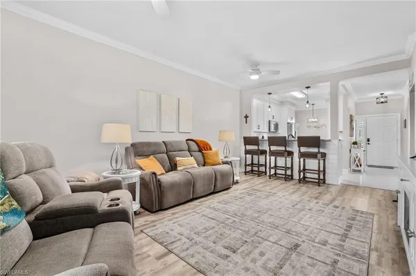 a living room with furniture and kitchen view