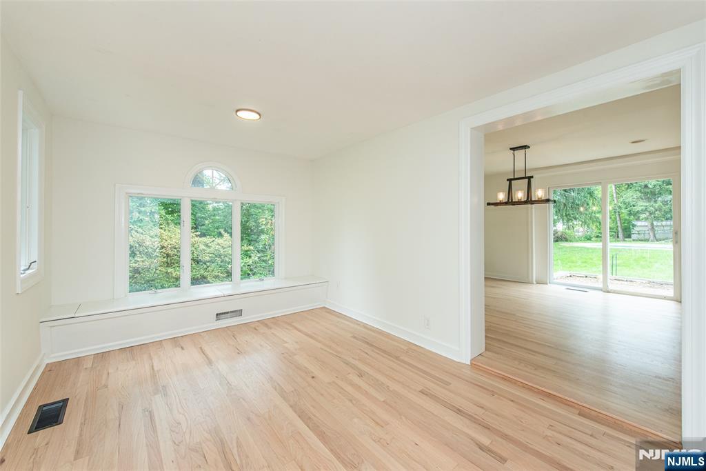 163 Sand Spring Road Morristown, NJ 07960 - Photo 17 of 39 an empty room with wooden floor and windows