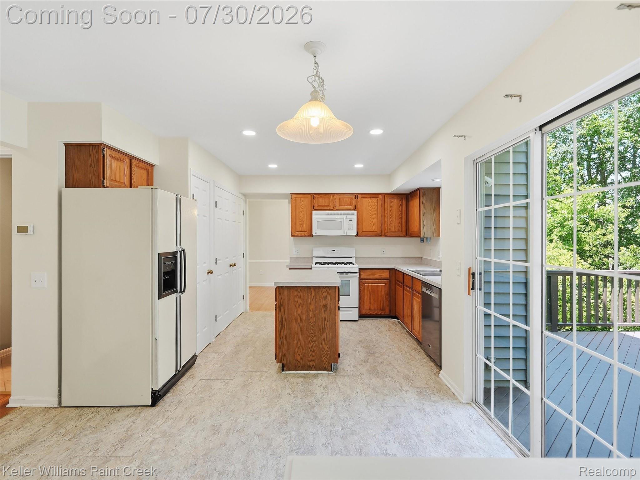 543 Arlington Drive Rochester, MI 48307 - Photo 13 of 59 Spacious kitchen featuring wood cabinetry, white appliances, and a central island