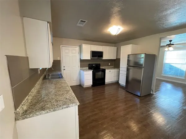 a kitchen with a refrigerator and a sink