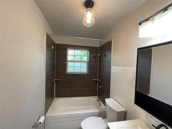 a bathroom with a toilet a sink and bathtub