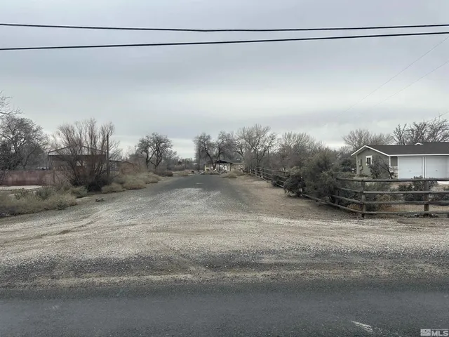 a view of dirt field with trees
