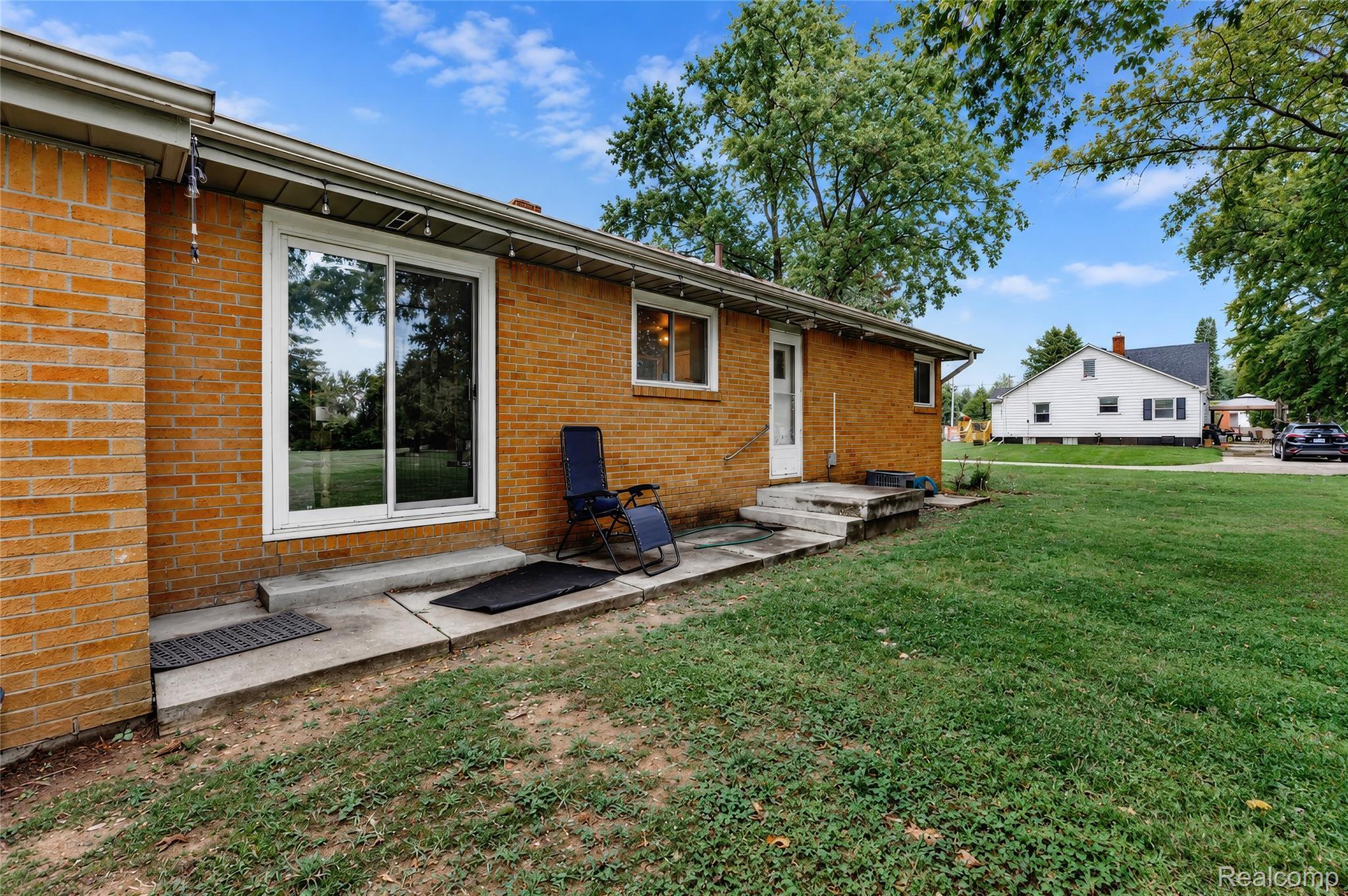 4499 South Linden Road Flint, MI 48507 - Photo 36 of 36 Brick exterior with multiple windows and a sliding glass door