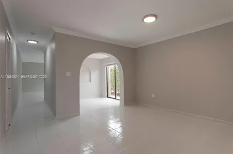 a view of a big room with windows and chandelier