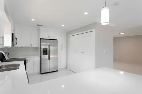 a kitchen with stainless steel appliances refrigerator sink and microwave