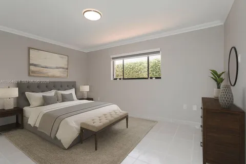 a bedroom with bed and a potted plant