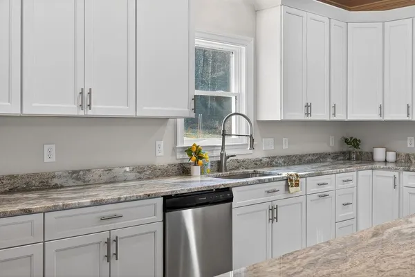 a spacious bathroom with a double vanity sink a mirror and a bathtub