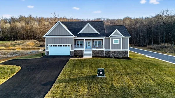 a living room with furniture and a view of kitchen