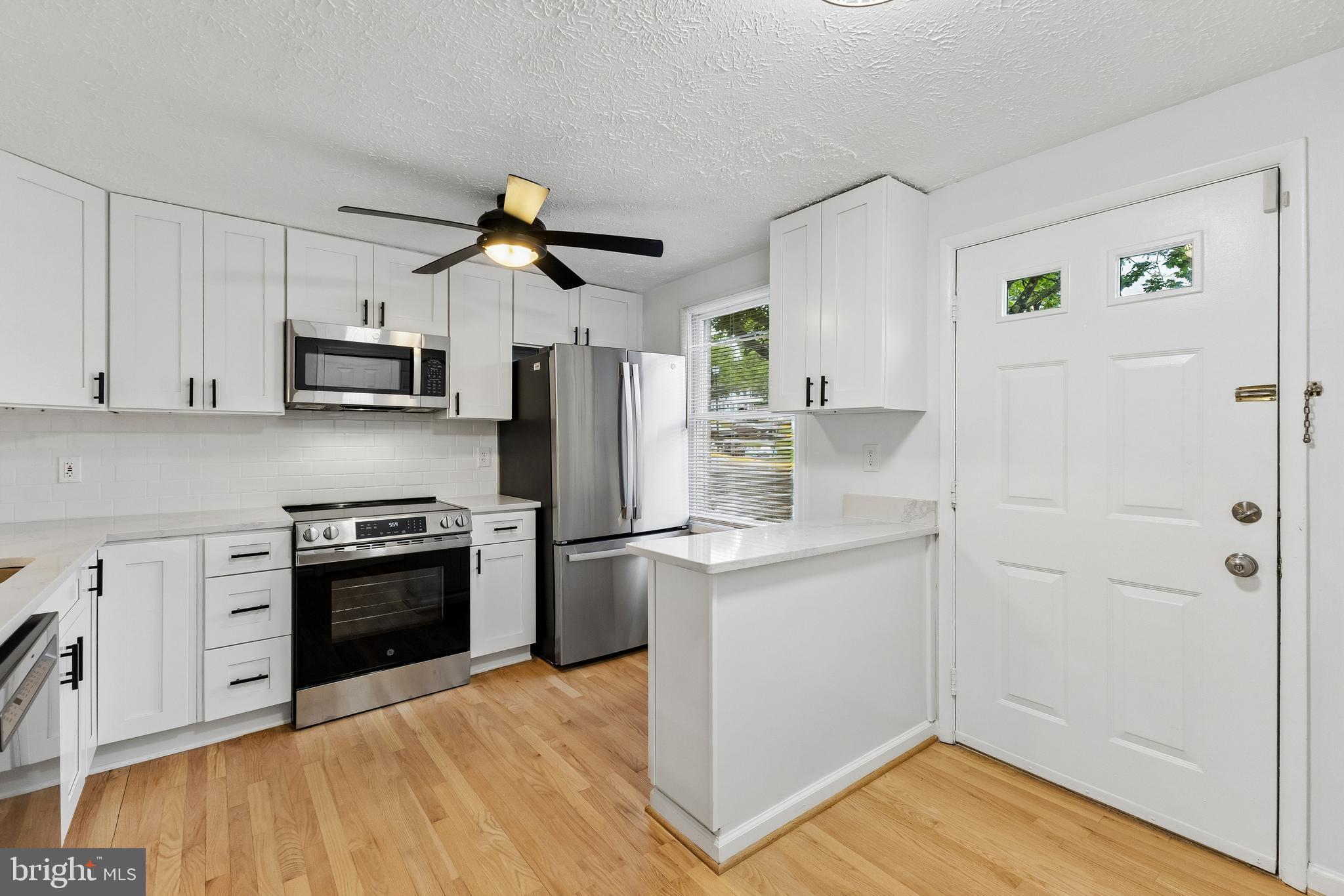 8317 Brookvale Court Springfield, VA 22153 - Photo 15 of 33 a kitchen with stainless steel appliances a refrigerator stove and sink