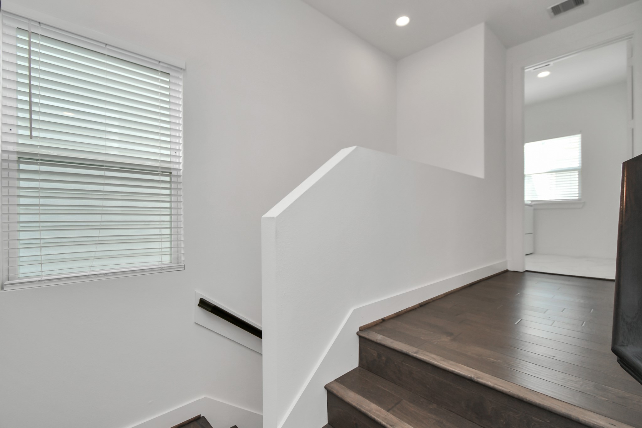 853 Mansfield Street, Unit E Houston, TX 77091 - Photo 21 of 47 a view of an empty room with wooden floor and a window