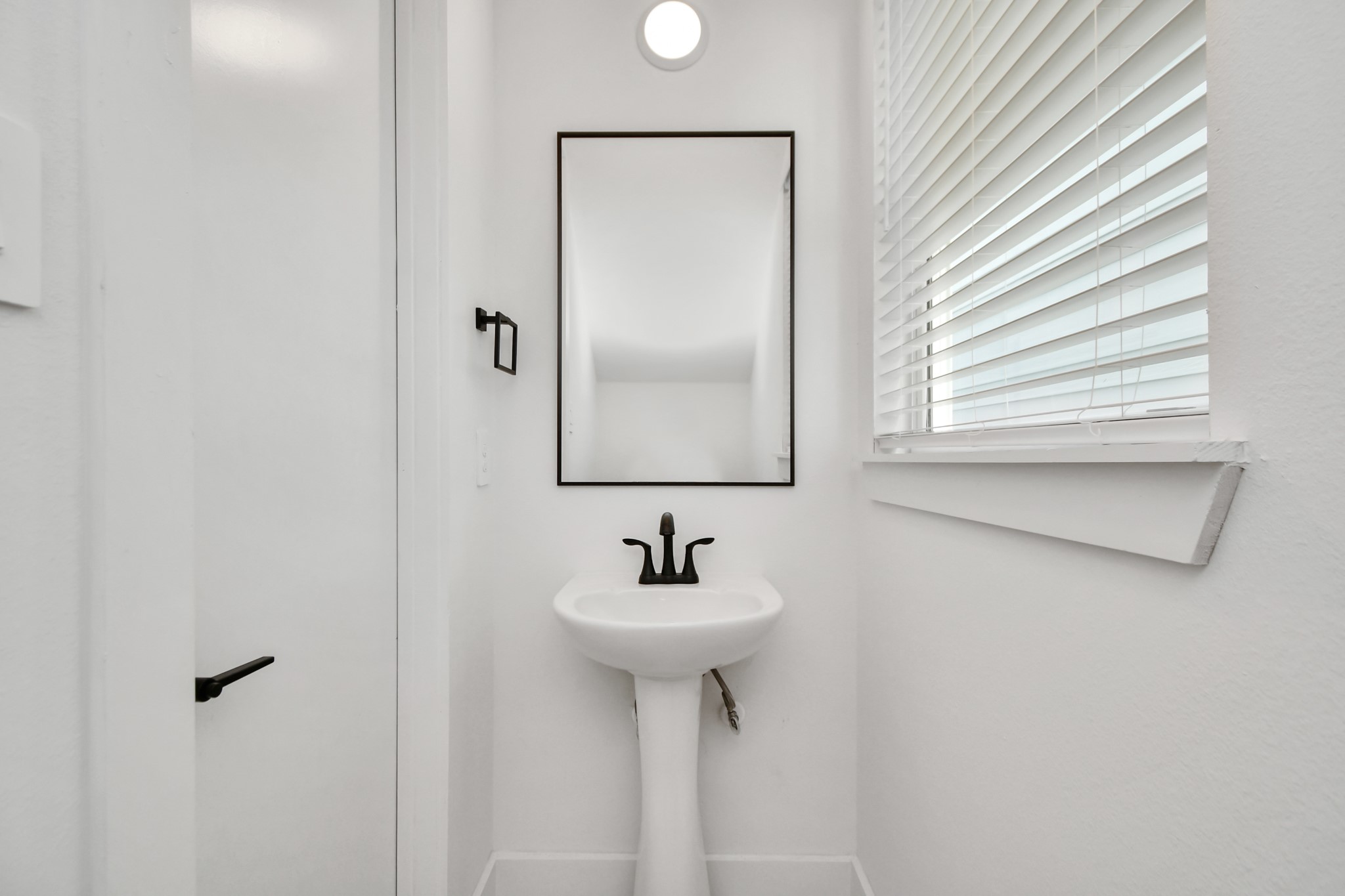 853 Mansfield Street, Unit E Houston, TX 77091 - Photo 9 of 47 a bathroom with a sink and a mirror