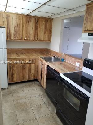 10425 Southwest 112th Avenue, Unit 211 Miami, FL 33176 - Photo 2 of 18 a kitchen with granite countertop a sink and a stove