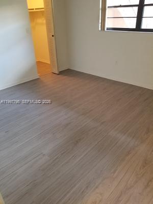 10425 Southwest 112th Avenue, Unit 211 Miami, FL 33176 - Photo 5 of 18 a view of a room with wooden floor