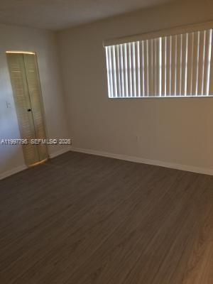 10425 Southwest 112th Avenue, Unit 211 Miami, FL 33176 - Photo 6 of 18 an empty room with wooden floor and windows
